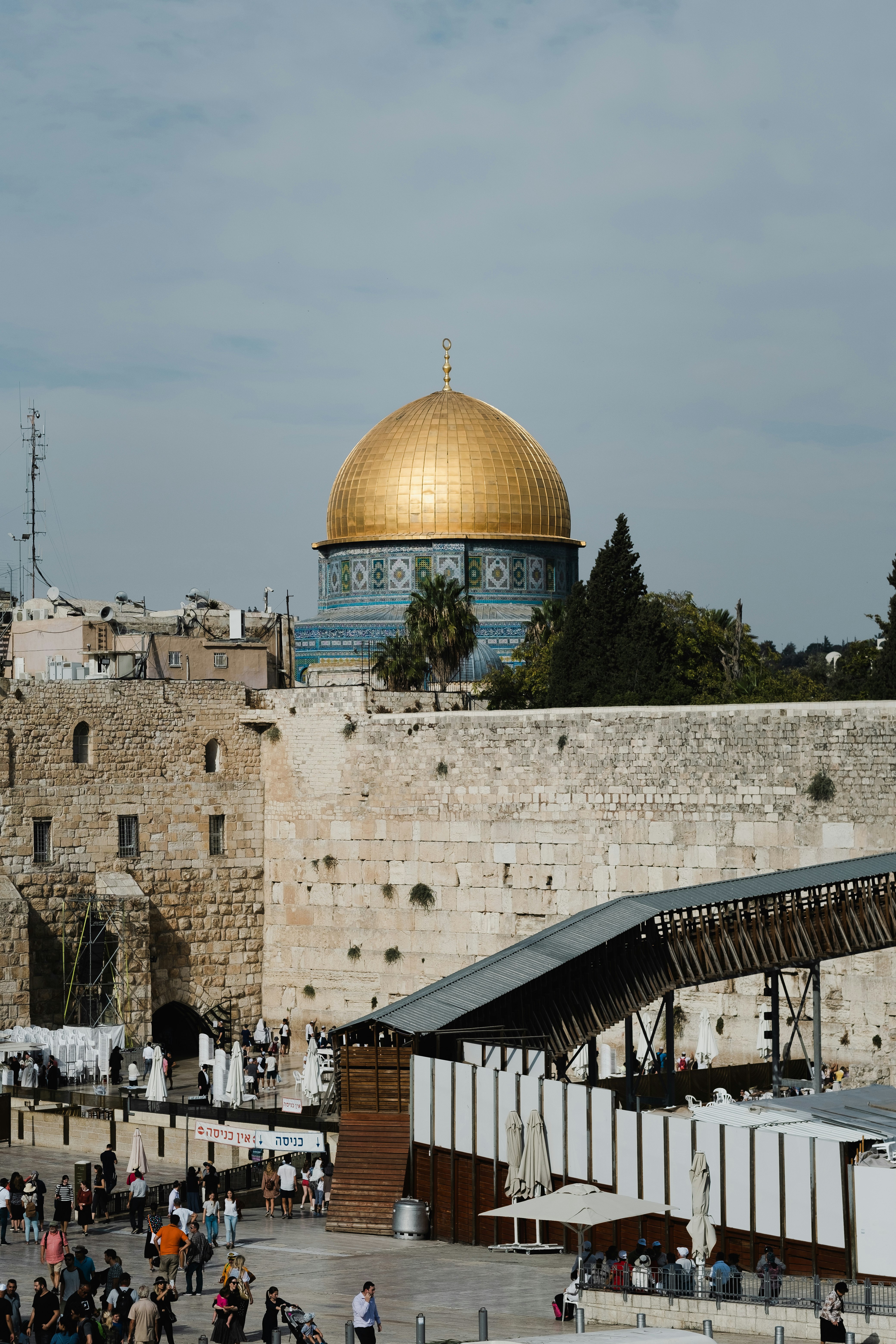 people walking near Dome of the Rock in Jerusalem under white and blue sky